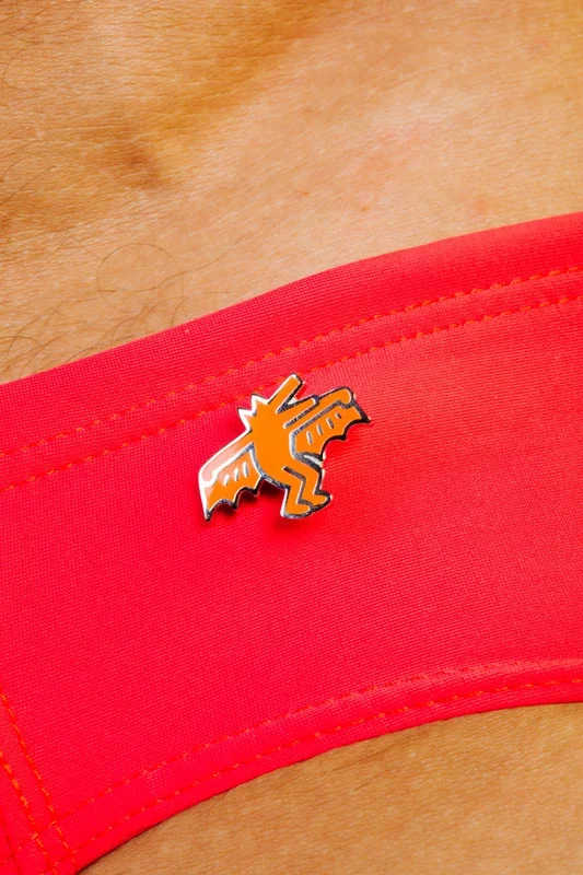 KEITH HARING BAT DOG PIN – ORANGE